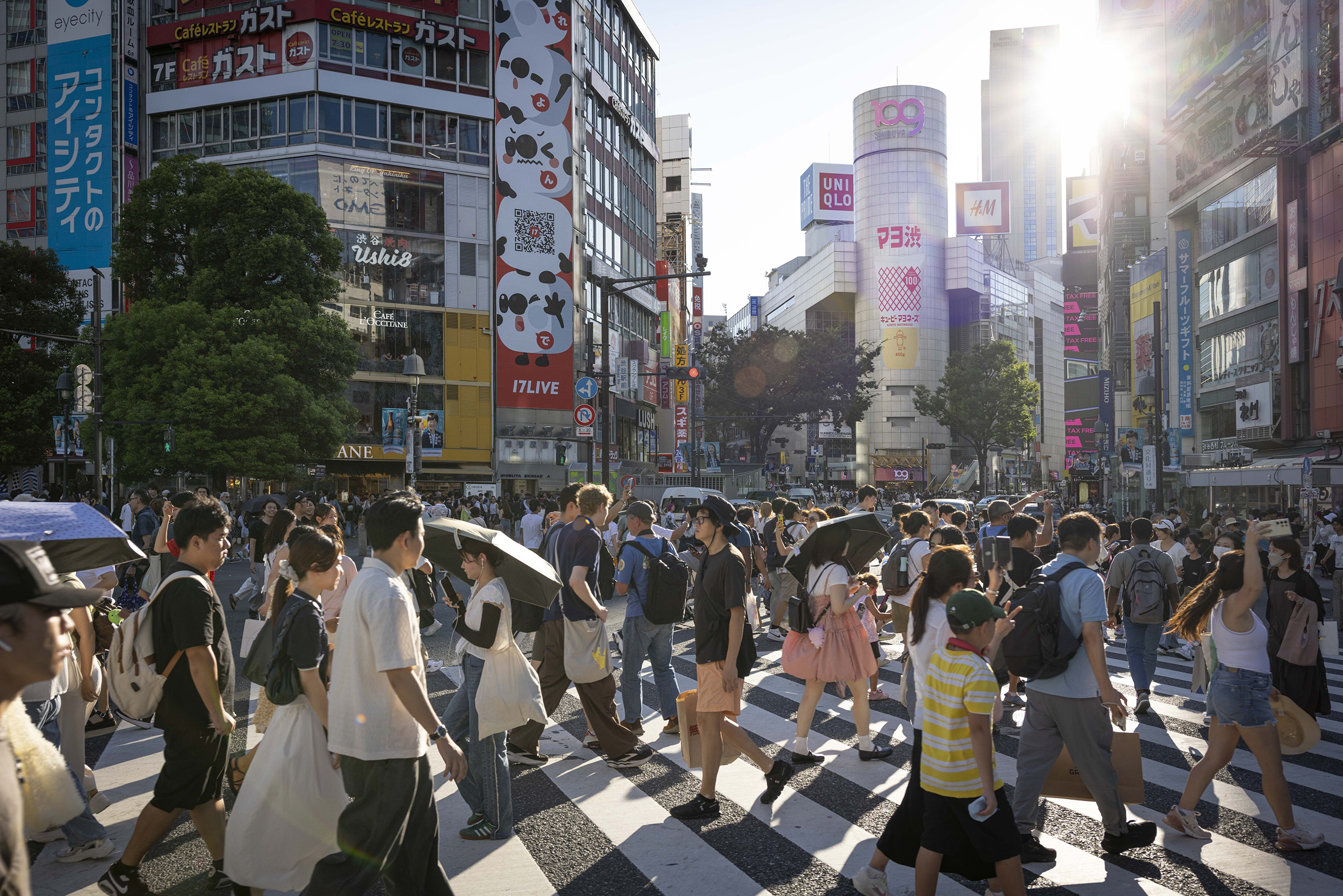 Crowds of people crossing Shibuya Crossing in Tokyo.