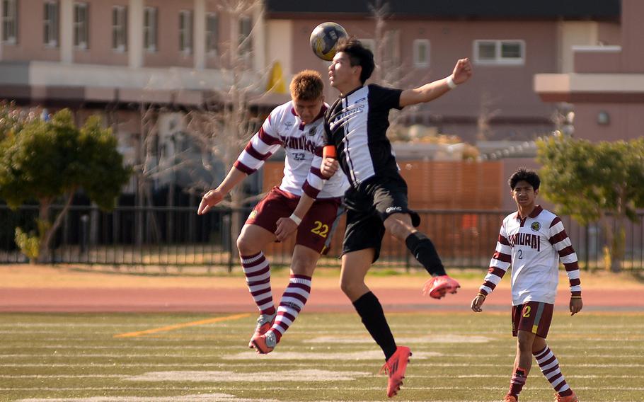 Noah Charles and Taiki Fukushima battle to head the ball.