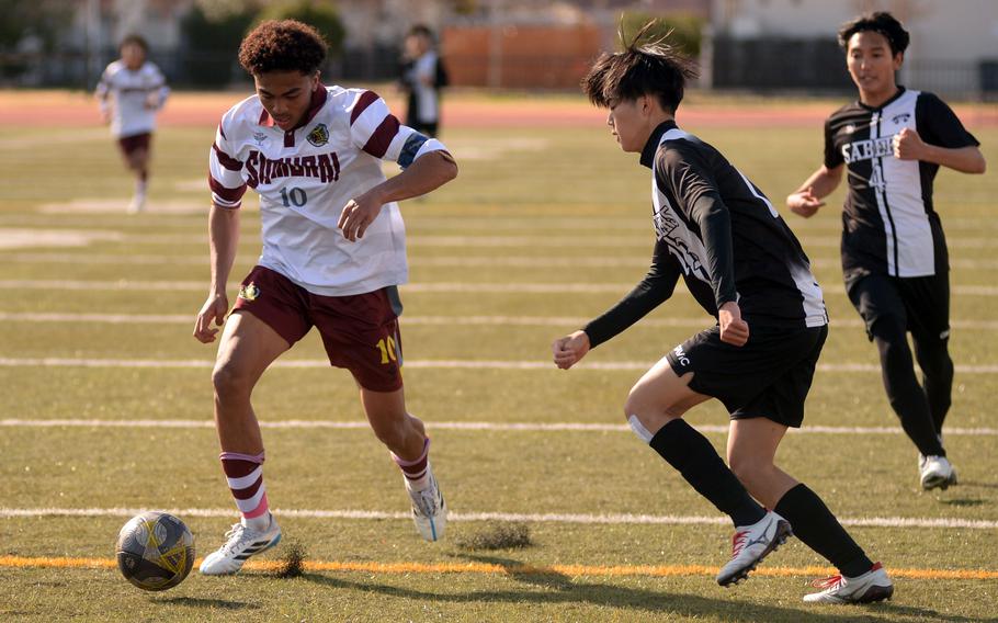 Jalen Cooley tries to maintain control of the ball.