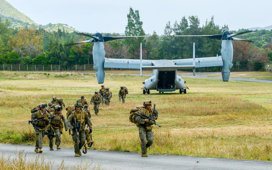 U.S. Marines walking off a MV-22 Osprey.