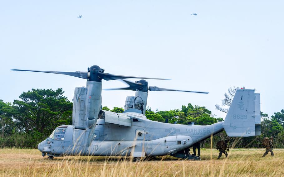 U.S. Marines walking off an Osprey.