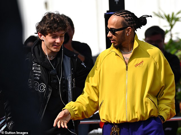 Hamilton, pictured with pole sitter Kimi Antonelli, arrived in the paddock wearing bright yellow