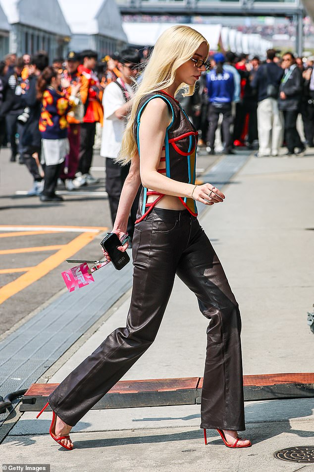 Anya ensured all eyes were on her on the track as she showed off her svelte frame in a colourful corset-inspired top with racy cutouts at the sides