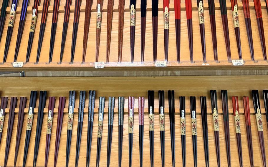 Two rows of colorful chopsticks are displayed.