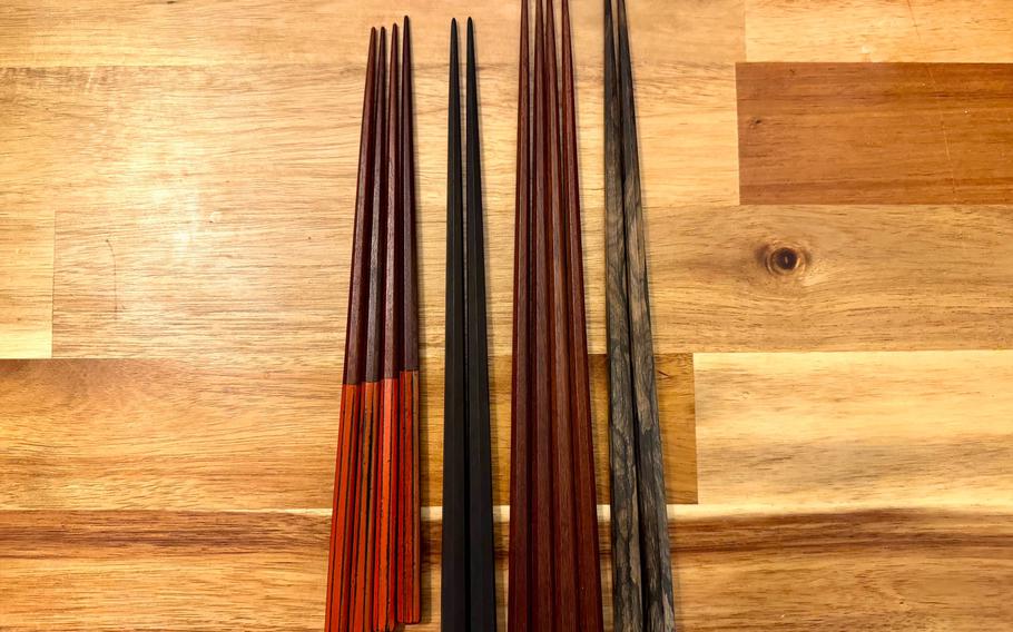 Four sets of decorative chopsticks are displayed.