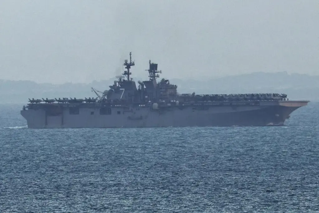 The USS Tripoli amphibious assault ship enters the Singapore Strait on March 17.