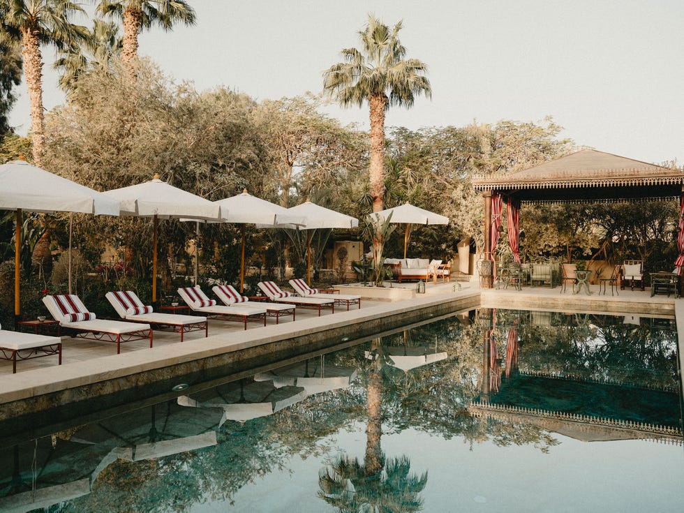 Luxury poolside area with loungers and a cabana.