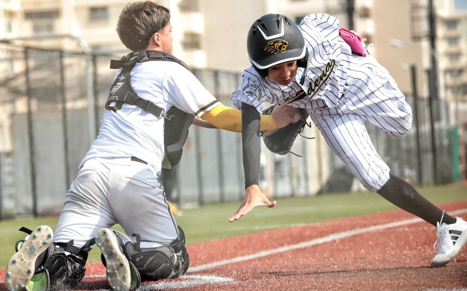 Bradley Miller tags a runner out at home.