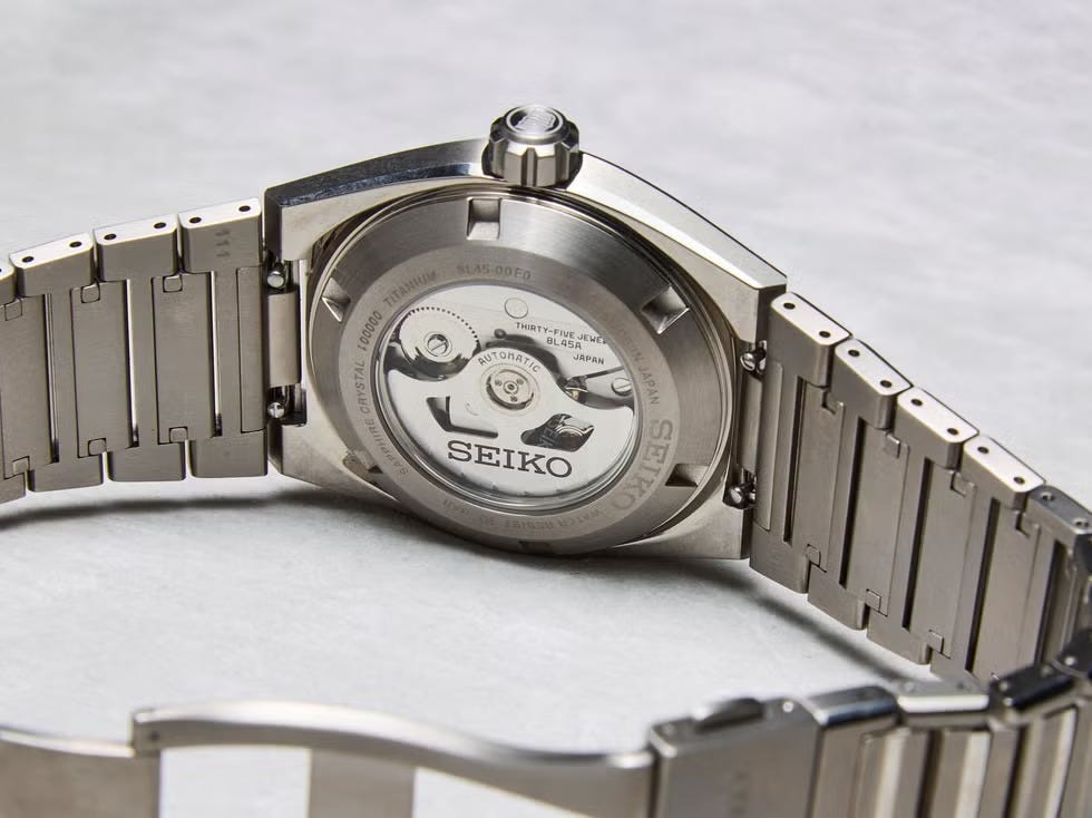 automatic watch with a stainless steel bracelet and visible movement