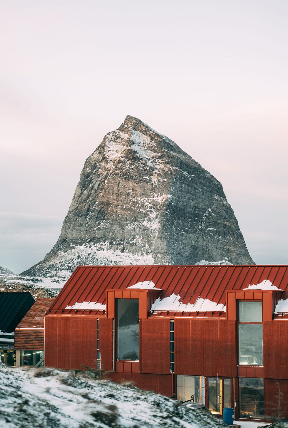 Mountain backdrop with modern architecture in foreground.
