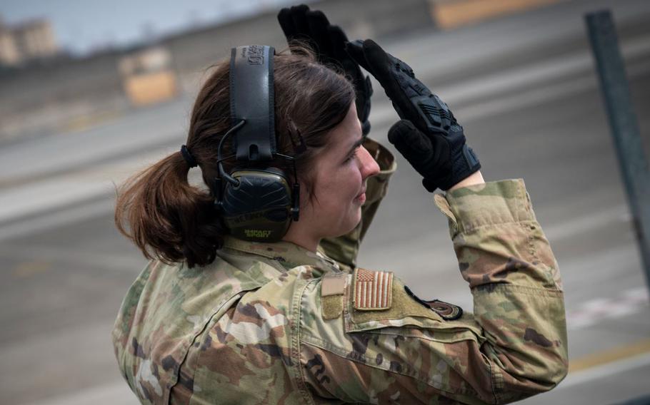 U.S. Air Force Senior Airman Demetria Therous, 374th Logistics Readiness Squadron passenger service representative, conducts spotting procedures.