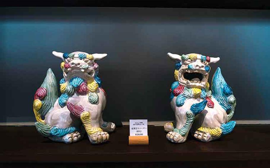 A pair of shisa is displayed on a shelf.