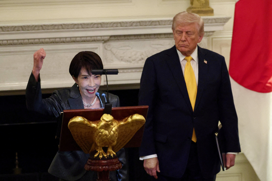 Japanese Prime Minister Sanae Takaichi raises her fist while saying ″Japan is back″ as she delivers remarks during a dinner hosted by U.S. President Donald Trump at the White House in Washington, D.C., U.S., March 19, 2026. [REUTERS/YONHAP]