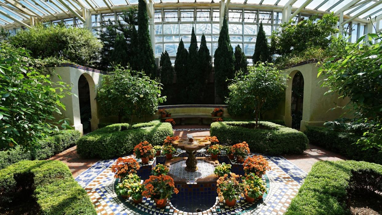 MISSOURI, UNITED STATES- APRIL 10, 2019: Architecture of terrace patio and natural fountain decorated in Climatron geodesic conservatory dome at Missouri Botanical garden- St.Louis town, MO