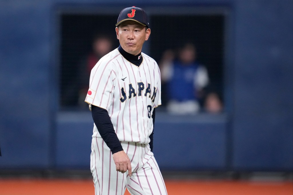 Head coach Hirokazu Ibata of Japan calls a pitching change during a game.