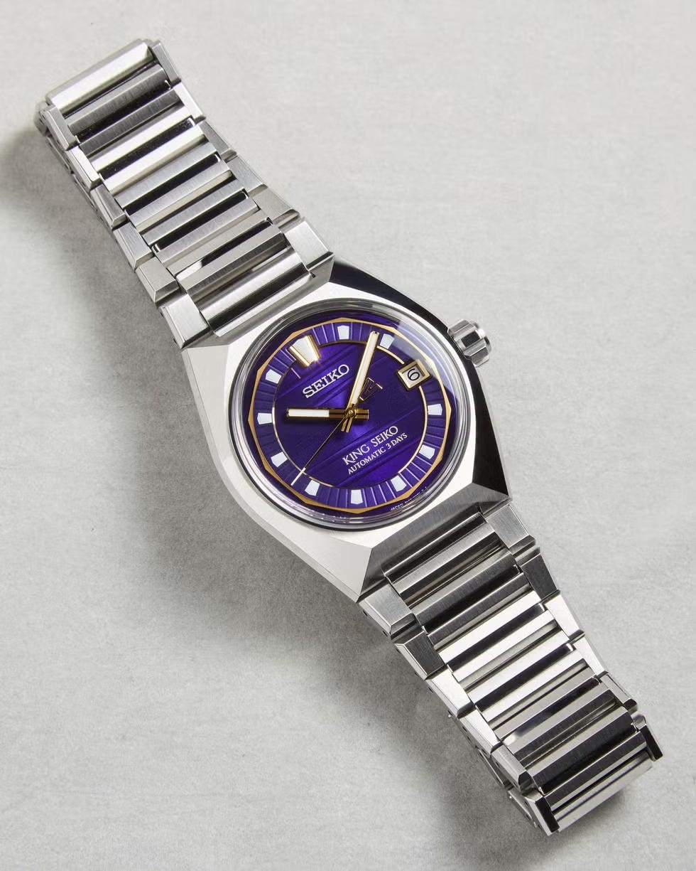 automatic wristwatch with a purple dial and stainless steel bracelet