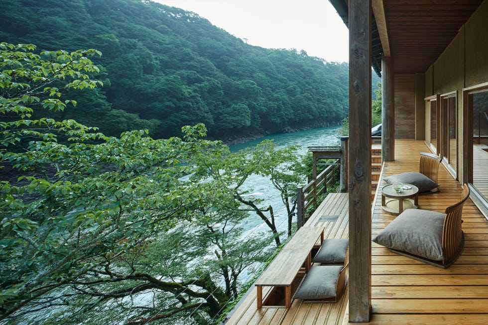deck area overlooking a river surrounded by trees deck area overlooking a river surrounded by trees