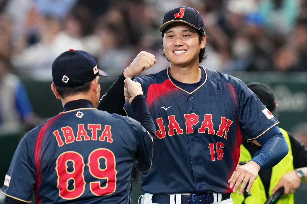 Shohei Ohtani smiling and fist-bumping manager Hirokazu Ibata.Japan's Shohei Ohtani, right, interacts with manager Hirokazu Ibata before the start of a World Baseball Classic Pool C game between Japan and Taiwan Friday, March 6, 2026 in Tokyo. 