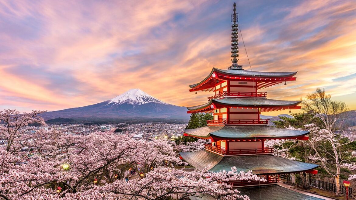 Cherry blossom: What is sakura season in Japan? Mount Fuji in the distance, perfectly framed by the cherry blossom by Omiya Bridge in Oshino Hakkai village