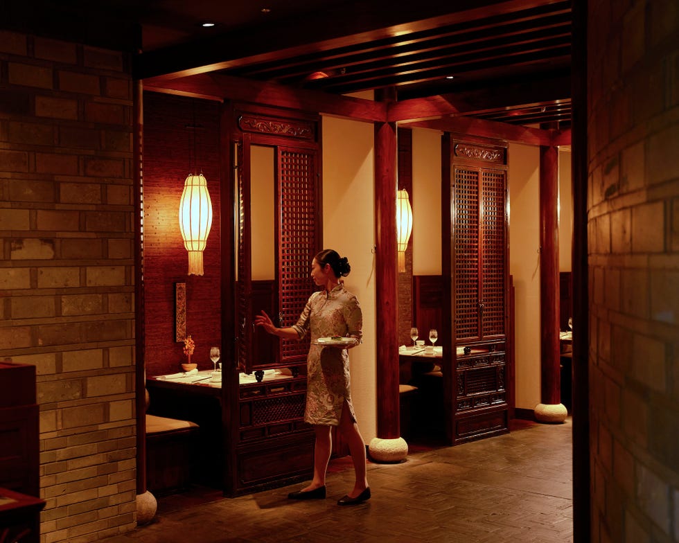 restaurant setting with a server and private dining areas restaurant setting with a server and private dining areas