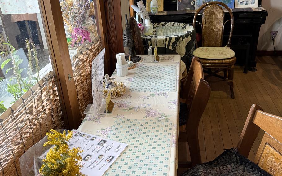 A long table runs underneath a tall window.