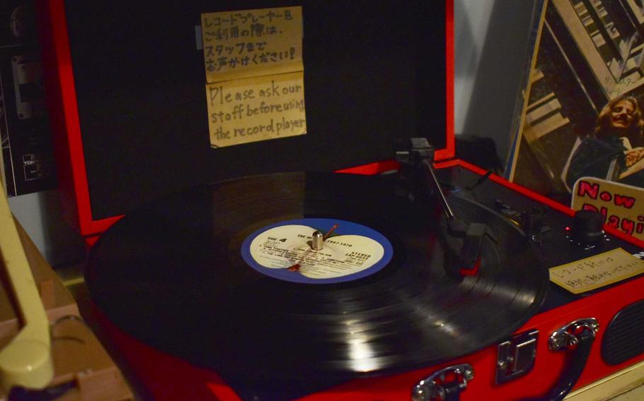 A record rests on an old-fashioned record player.