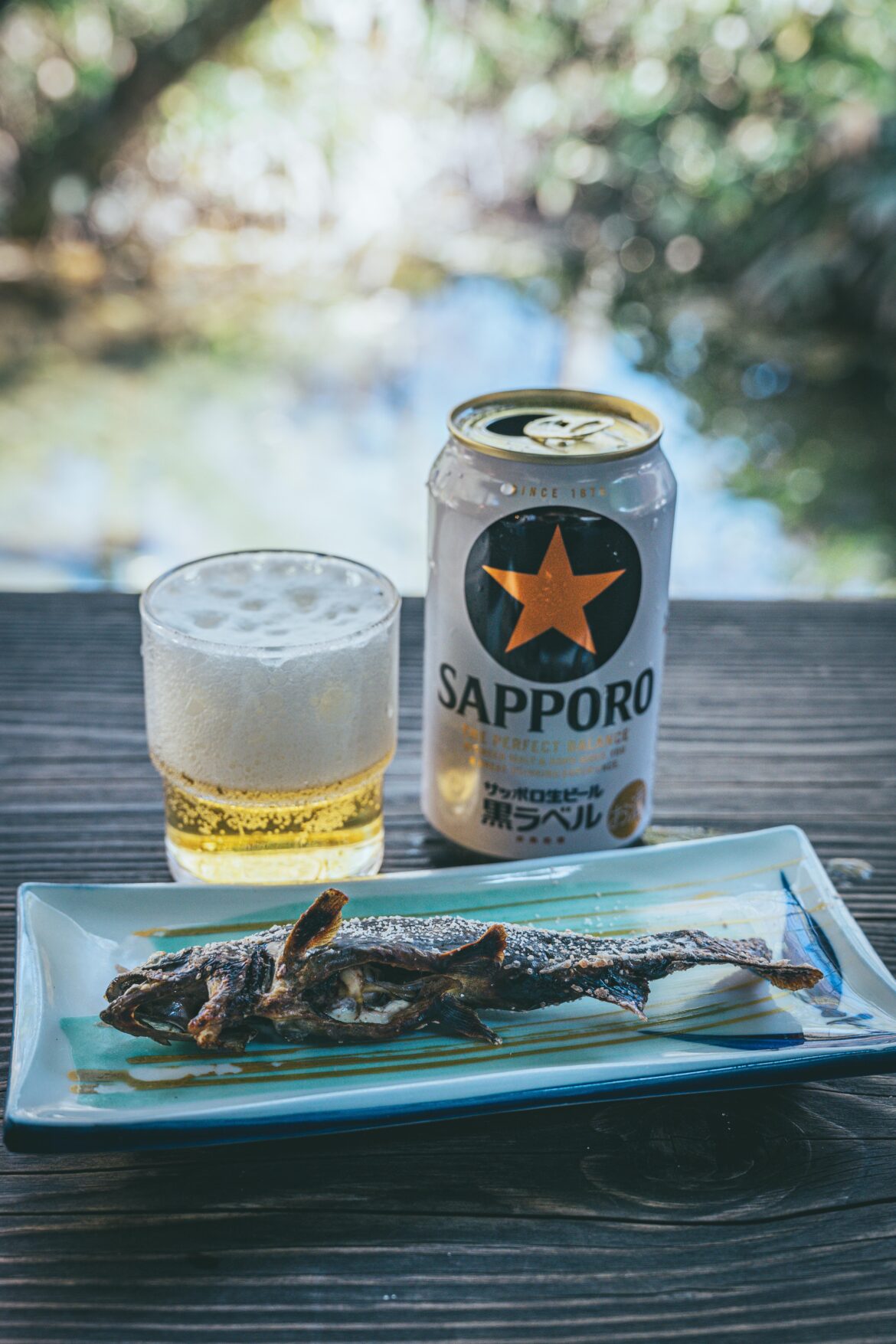 Salt-grilled Iwana (River Fish) with a cold Sapporo Beer in Kamikochi, Japan.