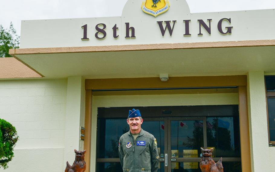 The commander of the 18th Wing poses outside his headquarters.