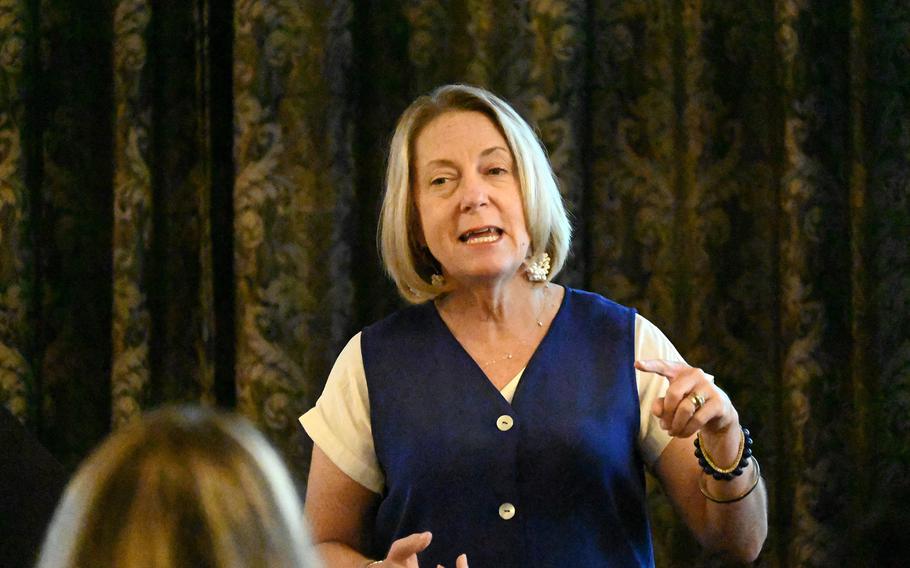A woman speaks at a seminar.