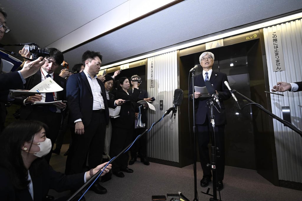 Naoki Fujii (right), president of Narita International Airport Corp., speaks to reporters in Tokyo on April 2. Photo: Kyodo