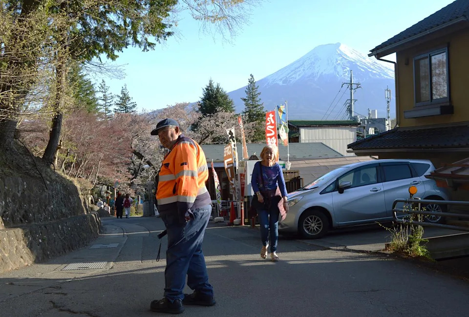 The city has hired several dozen retirees to corral foot traffic during peak season, one of the economic benefits that go hand in hand with a tourism boom.