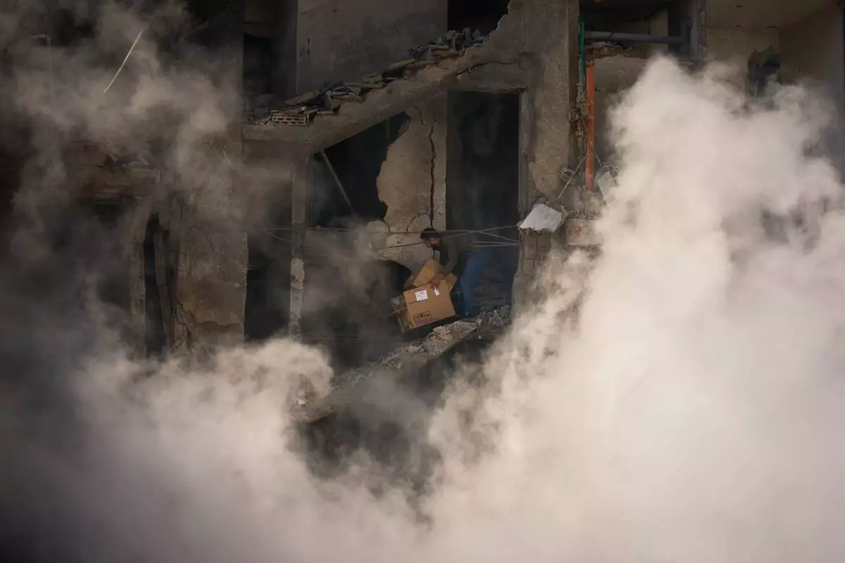 A man gathers his belongings from his home, which has been destroyed in an Israeli airstrike a day earlier in Beirut, Lebanon, Thursday, April 9, 2026. (AP Photo/Emilio Morenatti)
