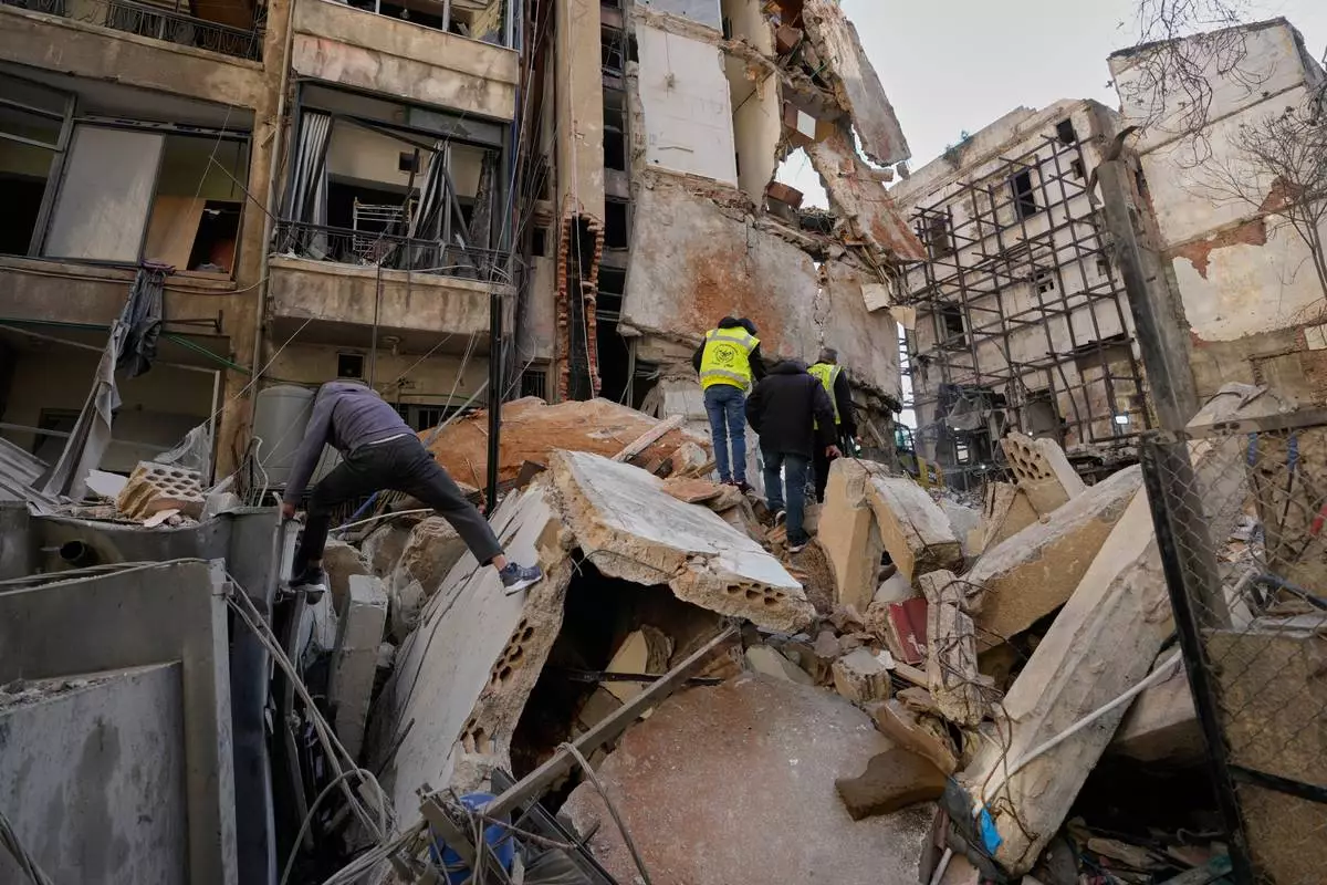 People inspect the rubble of a building destroyed in an Israeli airstrike a day earlier in Beirut, Lebanon, Thursday, April 9, 2026. (AP Photo/Hussein Malla)