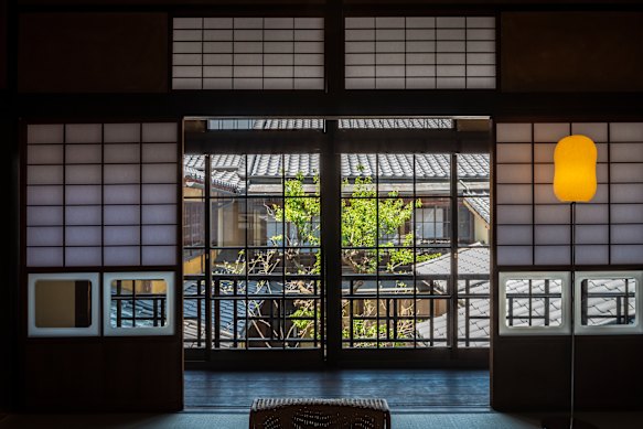 Gracious guestrooms, like this one inside one of the preserved buildings of the Nipponia Hotel, overlook manicured, bonsai-filled courtyards.