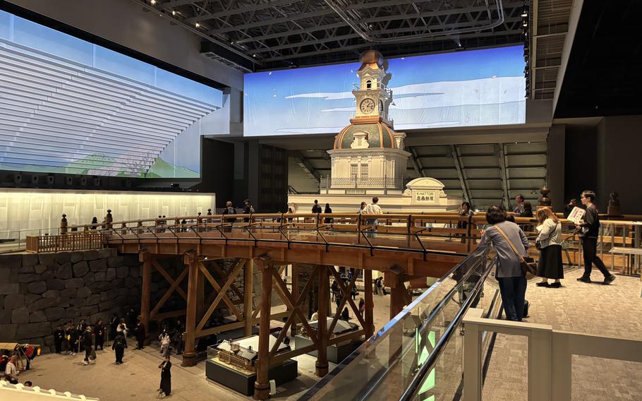 Visitors walk on a bridge.