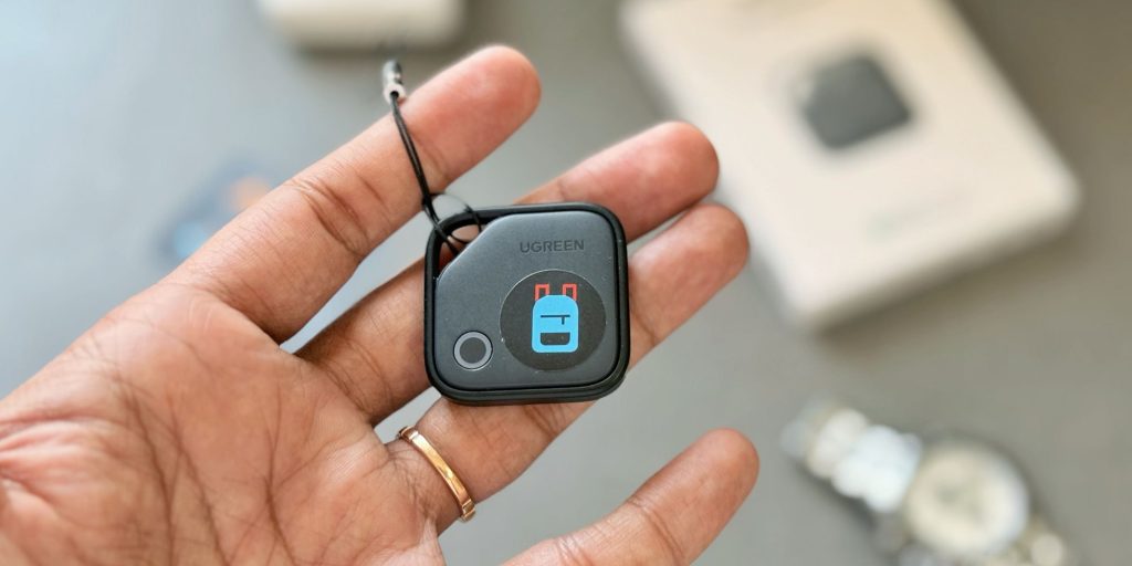 Image showing a hand holding UGREEN's Finder Tag item tracker.
