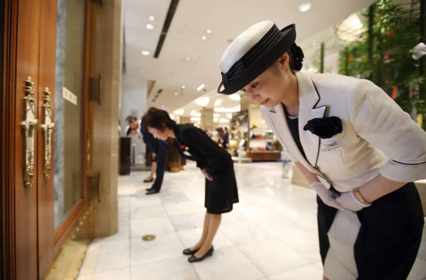 Department store staff prepare to open their doors to customers