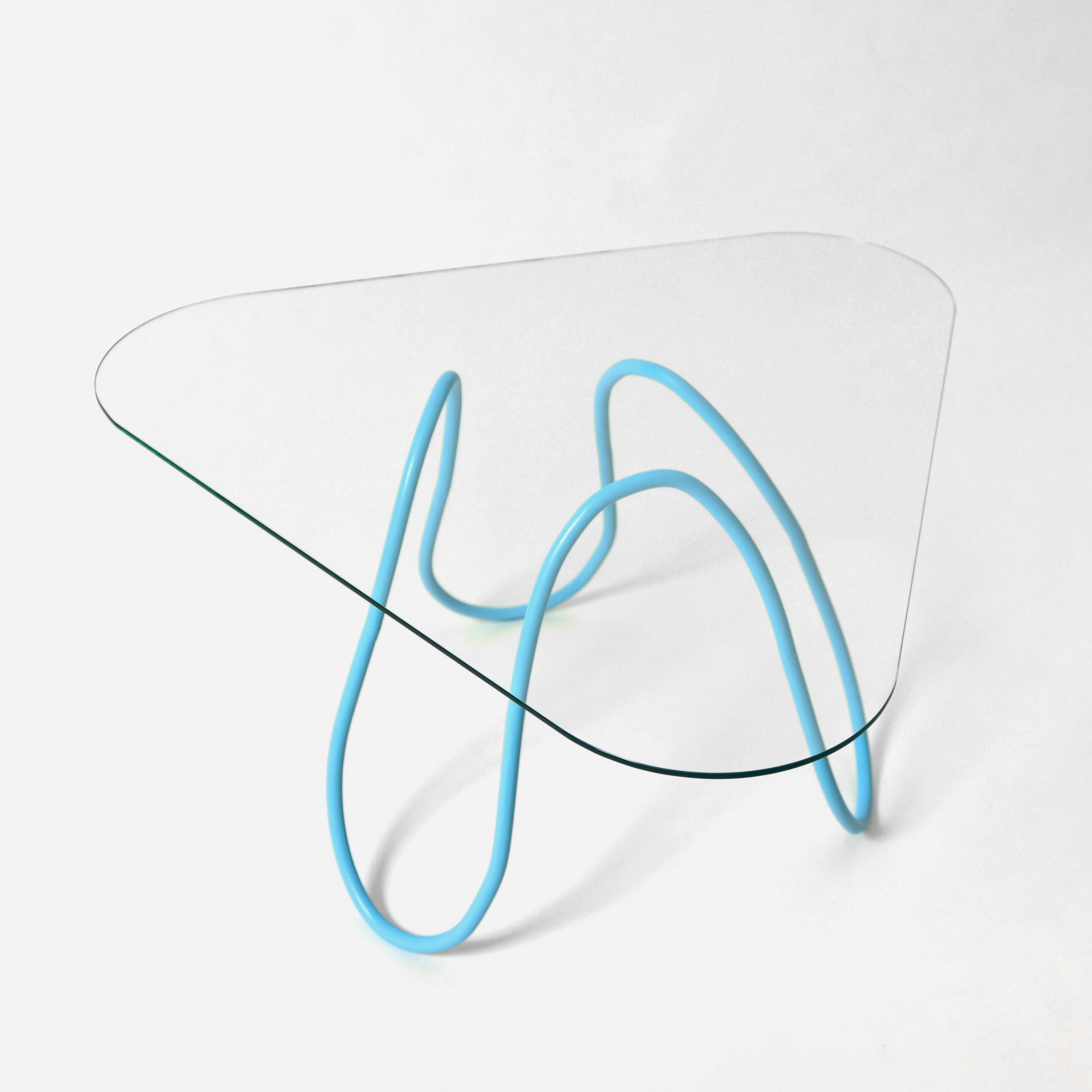 a glasstop table with blue wire legs