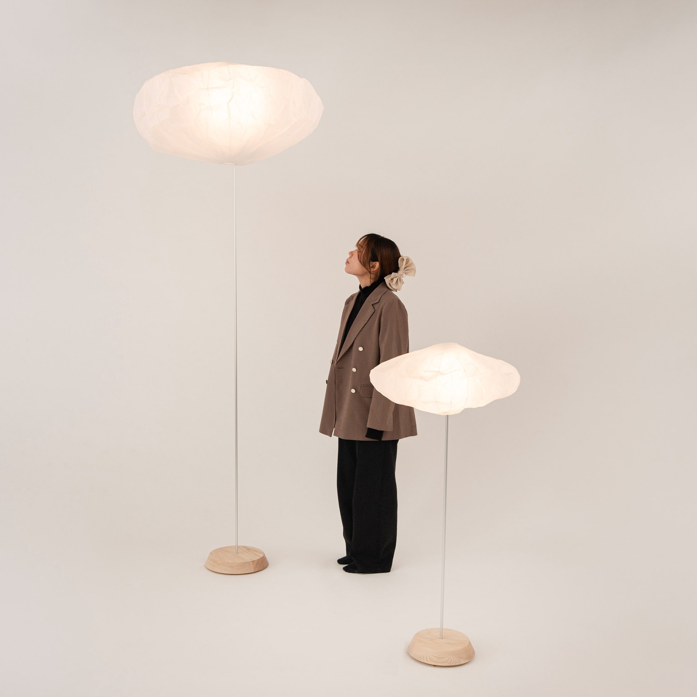 a photograph of a person surrounded by floor lamps