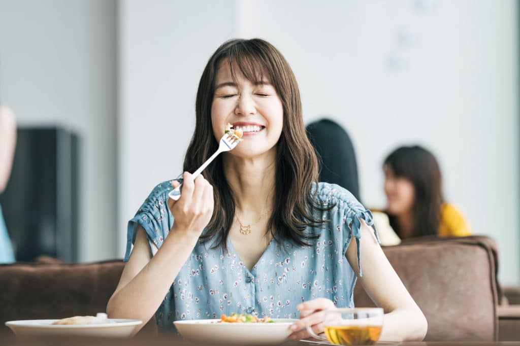 Single woman enjoying food - singles lifestyle in Japan