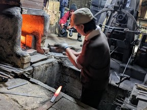 Watching a local master blacksmith forge a kitchen knife in Sakai City.