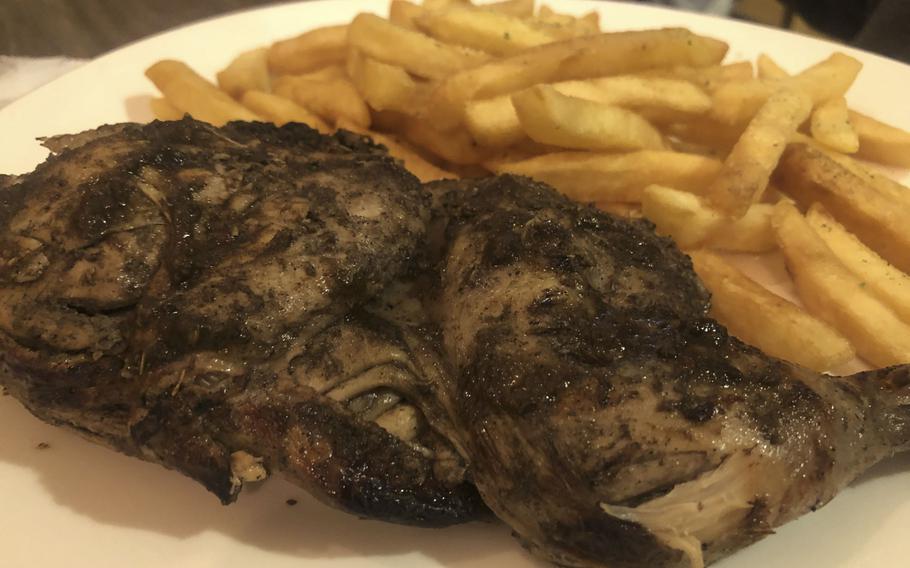 Ribs and french fries on a plate.