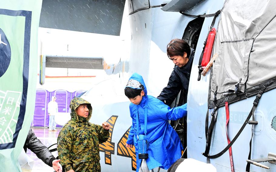 A boy disembarks after touring the inside of a Marine Corps MV-22 Osprey tiltrotor aircraft.