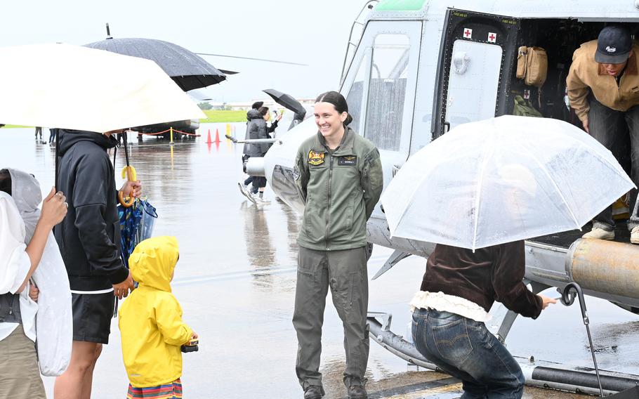 Festivalgoers tour the inside of a Marine Corps UH-1Y Venom helicopter.