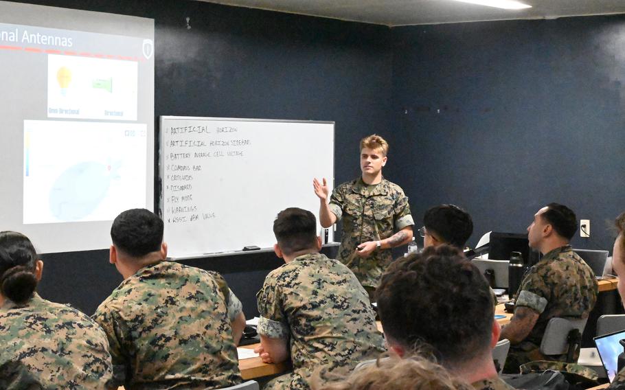 A Marine gives a lecture to a class of fellow Marines.