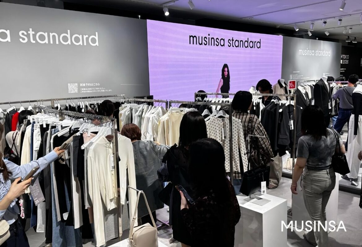 Shoppers browse through Musinsa Standard apparel at the brand