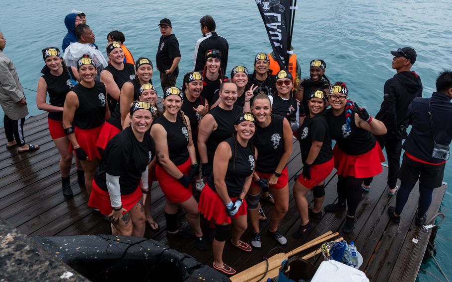 A dragon boat team smiling for a group photo.