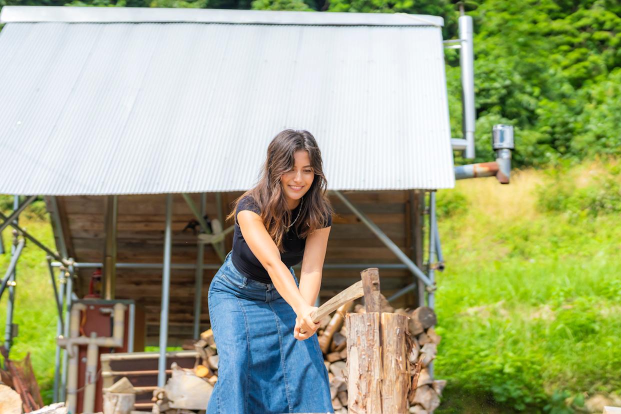 A woman hacking wood in Japan.