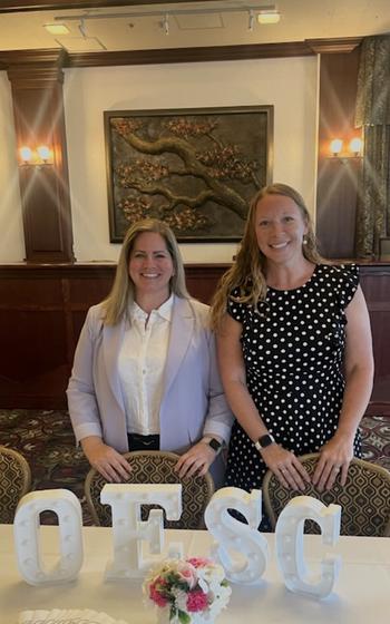 Ashley and Liz; two women from Okinawa Enlisted Spouse Club smiling for a photo.
