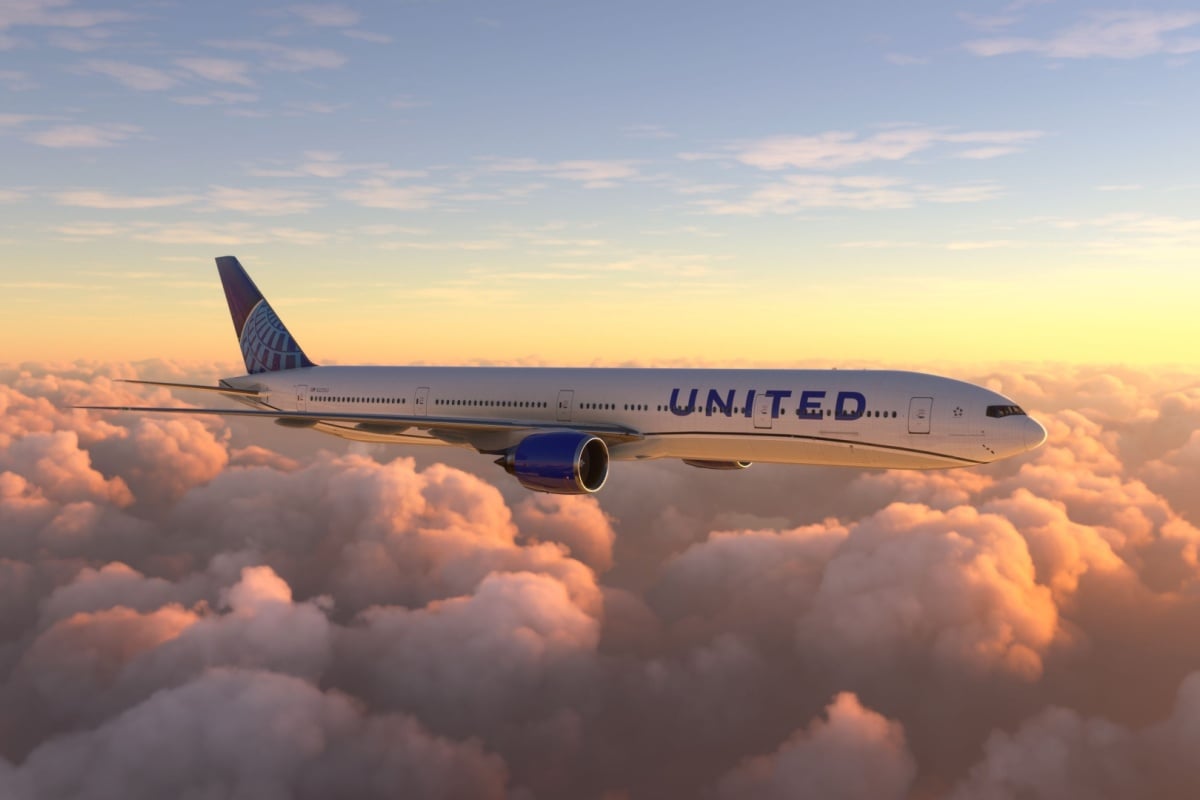 A United Airlines plane over a beautiful sunset